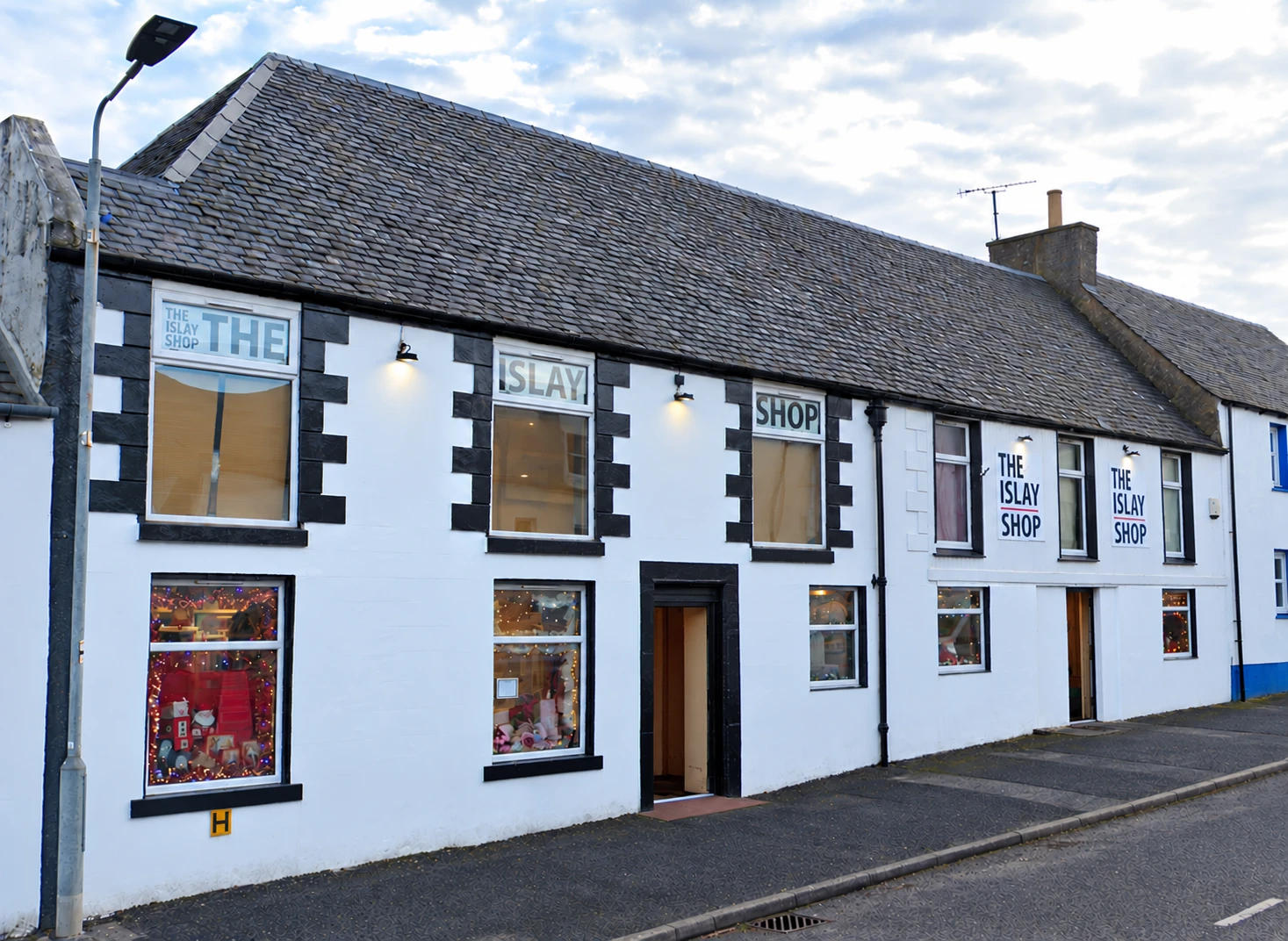 The Islay Shop on Main Street, Bowmore: a white-painted building with black window surrounds and the shop name in the windows